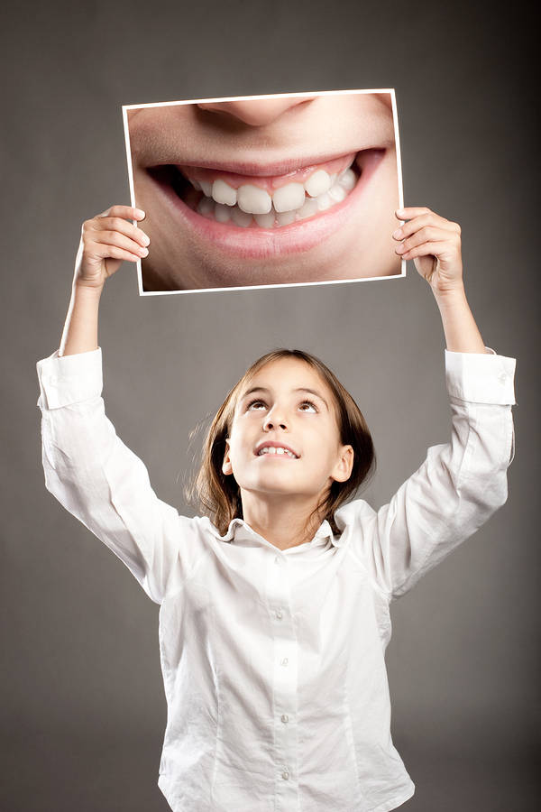 A girl getting ready to read a humorous book - literature that deals with laughter