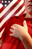 Boy pledging allegiance to US Flag