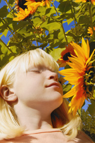 Girl smelling sunflower