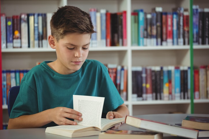 Student works on his 6th grade reading skills at school.