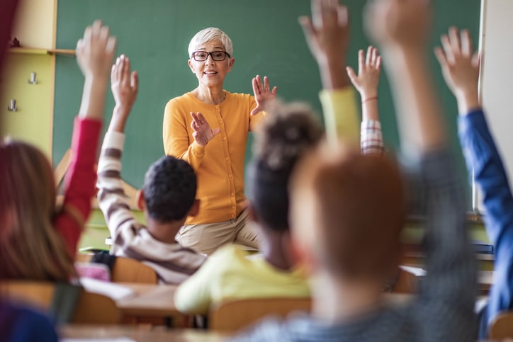 Teacher asks class a question. 7 challenges in teaching.