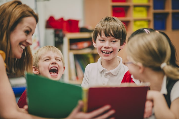 Elementary school class laughing at back to school jokes.