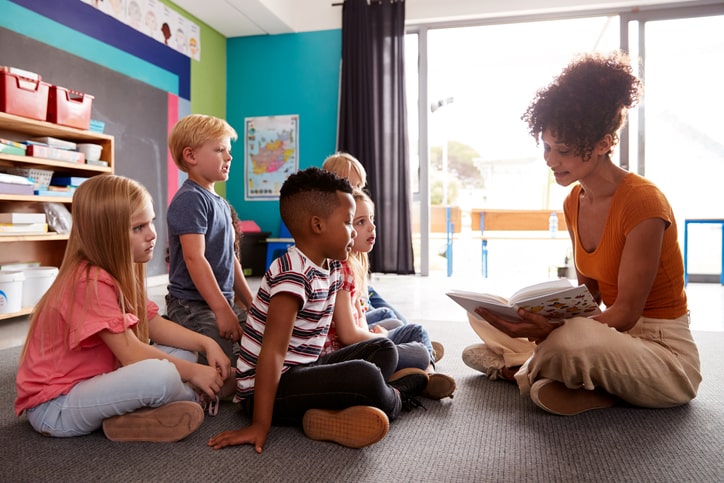 Teacher reads to class on the carpet. 5 Golden Rules for the Classroom 