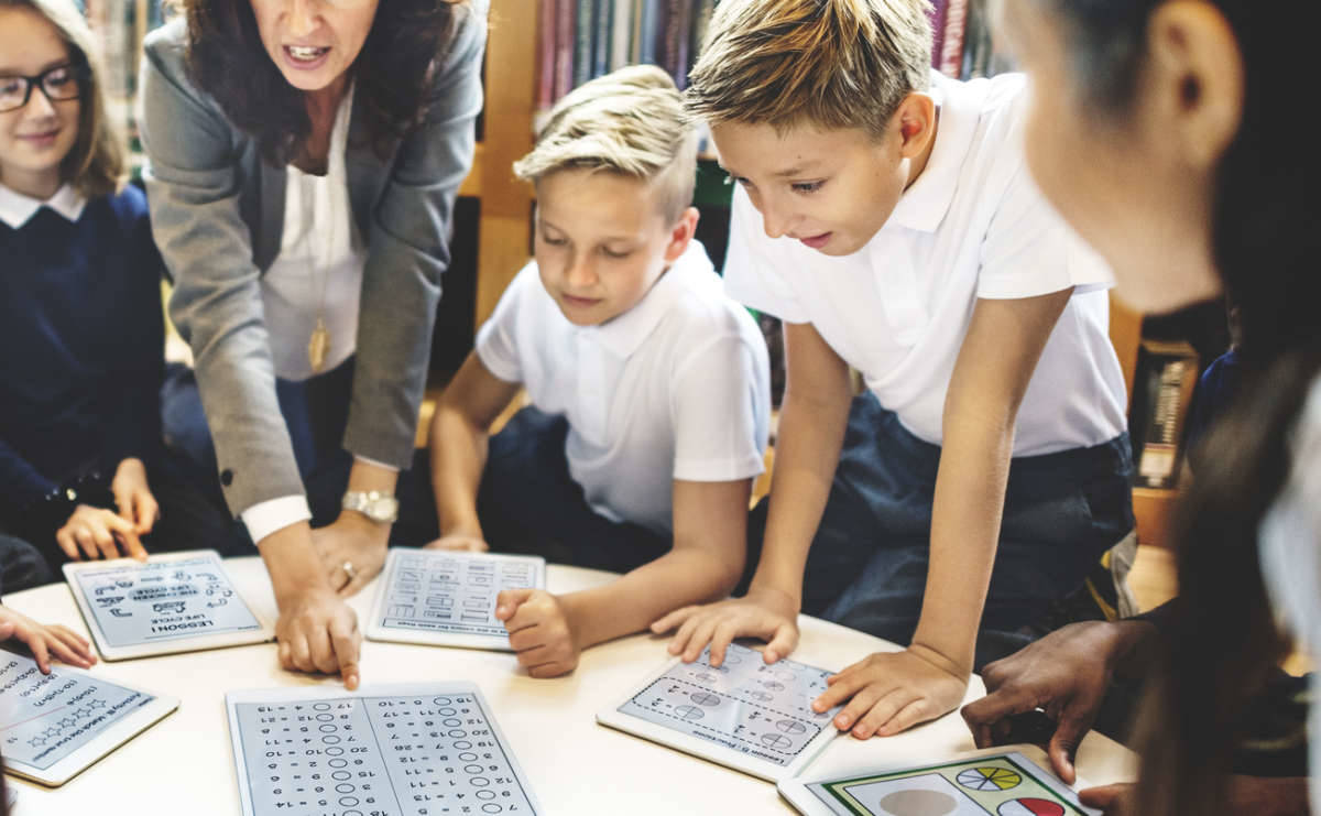 teacher and student using technology in the classroom