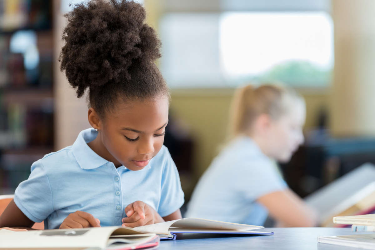 young girl learning to read and improve reading comprehension