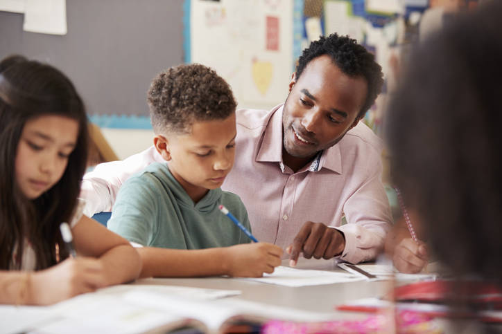 Teacher assisting student