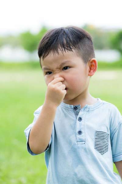 Little kid holding nose - read the Grossology books